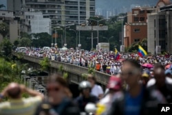 FILE - People protest to demand a recall referendum against Venezuela's President Nicolas Maduro in Caracas, Oct. 22, 2016.