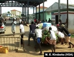 Youths push goods from Cameroon through the border to Equatorial Guinea, June 5, 2018.