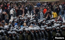 Law enforcement officers gather as they block opposition supporters in Moscow, Russia, March 26, 2017.
