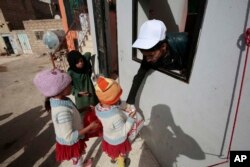 FILE - Yemeni children receive free food donated by Yemeni volunteers during the holy month of Ramadan, in Sanaa, Yemen, June 11, 2016.