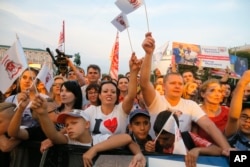 Supporters wave to Ukraine's Olympic team during a farewell ceremony in Kiev, Ukraine, Saturday, July 23, 2016. Ukraine will be represented by 205 sportsmen and women at the Olympic Games in Rio de Janeiro, Brazil.