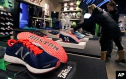 The word "Boston" accents the sole of the New Balance shoe on display at the storefront of the world headquarters of New Balance in the Brighton neighborhood of Boston, Dec. 28, 2016.