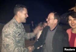 FILE - Jeffrey Fowle and his wife, Tatyana, are greeted by U.S. Air Force Col. John Devillier upon arrival at Wright-Patterson Air Force Base in Ohio after his release in North Korea, Oct. 22, 2014.