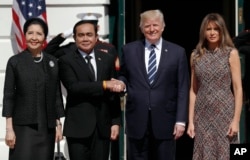 President Donald Trump and first lady Melania Trump greet Thailand's Prime Minister Prayuth Chan-ocha, and his wife Naraporn Chan-ocha at the White House in Washington, Oct. 2, 2017.