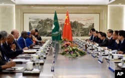 African Union Commission Chairperson Moussa Faki Mahamat (4th-L) speaks during a meeting with Chinese Foreign Minister Wang Yi (3rd-R) in Beijing, Feb. 8, 2018.
