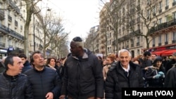 Patrick Meyer, center, walks with friends and fellow members of France's Jewish community.