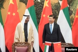 Sheikh Mohammed bin Zayed al-Nahyan (L), Crown Prince of Abu Dhabi and UAE's deputy commander-in-chief of the armed forces meets Chinese President Xi Jinping (R) during a signing ceremony at the Great Hall of the People in Beijing, Dec. 14, 2015.