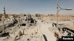 FILE - Damaged buildings are pictured during the fighting with Islamic State's fighters in the old city of Raqqa, Syria, Aug. 19, 2017. 