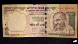 This photo illustration shows a 500 rupee Indian currency note.