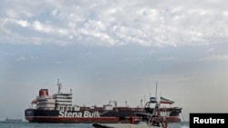 A boat of Iranian Revolutionary Guard sails next to Stena Impero, a British-flagged vessel owned by Stena Bulk, at Bandar Abbas port, July 21, 2019.