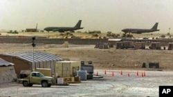 FILE - American military planes and support facilities are seen at the Al Udeid Air Base outside Doha, Qatar, in the Persian Gulf in this undated photo.
