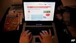 FILE - An Indian man is seen surfing the internet in New Delhi.