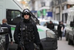 Algerian security forces guard the courtroom as former Algerian Prime Ministers Ahmed Ouyahia and Abdelmalek Sellal face corruption charges in Algiers, Dec. 4, 2019.