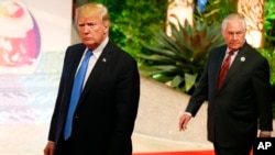 FILE - U.S. President Donald Trump, accompanied by Secretary of State Rex Tillerson, is pictured in Manila, Philippines, site of an ASEAN summit, Nov. 14, 2017.