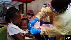 FILE- A child is vaccinated against Ebola in Beni, DRC, July 13, 2019.