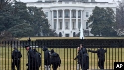 Secret Service officers search the south grounds of the White House in Washington, Jan. 26, 2015. 