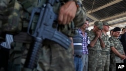 Turkish soldiers pray during the funeral of soldier Mehmet Yalcin Nane, killed July 23 by IS militants when they attacked a Turkish military outpost at the border with Syria, in the town of Gaziantep, southeastern Turkey, July 24, 2015. 