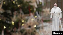 Pope Francis wears a protective mask before delivering his traditional Christmas Day Urbi et Orbi speech from inside the Hall of Blessings instead of from the St. Peter's square due to COVID-19 regulations, Vatican, Dec. 25, 2020.