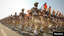 FILE - Members of the Iranian Revolutionary Guard march during a parade to commemorate the anniversary of the Iran-Iraq war (1980-88), in Tehran, Sept. 22, 2011. 