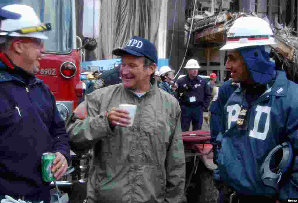 Actor and comedian Robin Williams (center) shares a laugh with rescue workers near the site of the World Trade Center collapse in lower Manhattan, Oct. 17, 2001. Williams spent time with rescue workers as well as surprising their wives with phone calls.