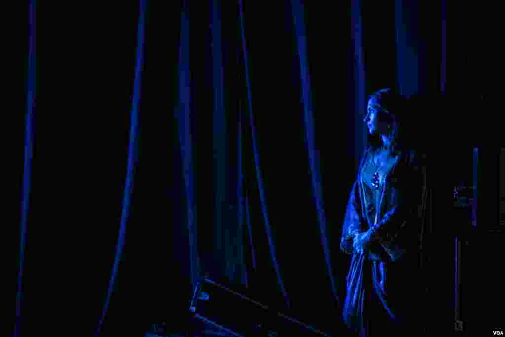 An actress waits in the wings for her turn to go onstage. (Photo: John Owens for VOA)
