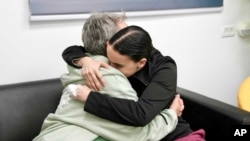 In this photo released by the Israeli Army, Emily Damari, right, and her mother Mandy near kibbutz Reim, southern Israel after Emily was released from captivity by Hamas militants in Gaza, Jan. 19, 2025. 