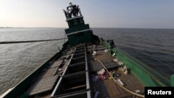 FILE - An abandoned boat which carried Rohingya and Bangladeshi migrants from Thailand is found off the coast near the city of Kuta Binje, Indonesia's Aceh Province.