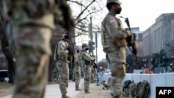 Members of the National Guard stand at Capitol Hill in preparation for the U.S. presidential inauguration a week after a pro-Trump mob broke into and took over the Capitol, Jan. 14, 2021.