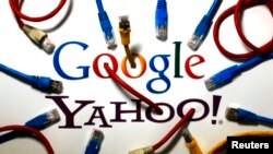 FILE - An illustration shows the logos of Google and Yahoo connected with LAN cables in a Berlin office in Germany, Oct. 31, 2013.