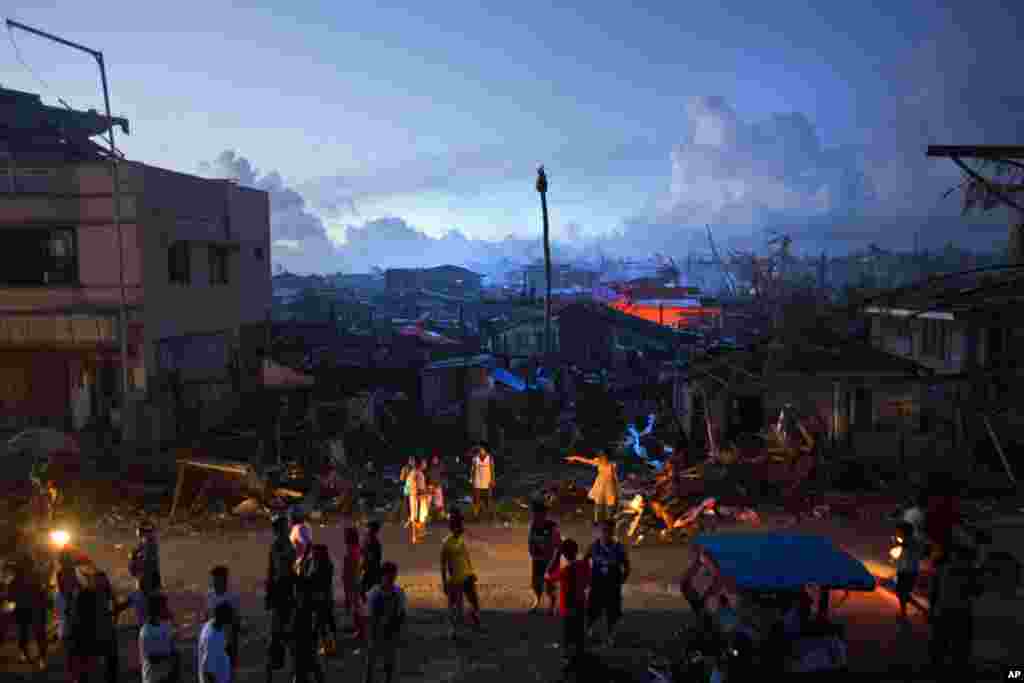 Typhoon Haiyan survivors wait by the roadside in the destroyed town of Guiuan, Philippines, Nov. 14, 2013.&nbsp;