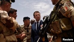 FILE - French President Emmanuel Macron visits French troops in Africa's Sahel region in Gao, northern Mali, May 19, 2017. 