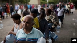 Residents line up to fill containers with water from a natural spring in Cape Town, South Africa, Feb. 2, 2018. South Africa's drought-hit city of Cape Town introduced new water restrictions in an attempt to avoid "Day Zero," the day in mid-April when it might have to turn off most taps.