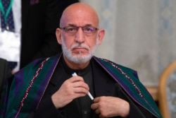 FILE - Former Afghan President Hamid Karzai prepares to attend a meeting in Moscow, Russia, May 28, 2019.