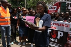 FILE - A protester reads aloud a petition against increased violence against girls and women in Malawi. (Lameck Masina/VOA)