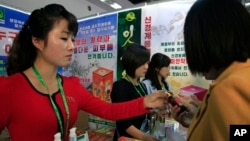 FILE - North Koreans look at products at an international trade fair held Sept. 25, 2017, in Pyongyang.