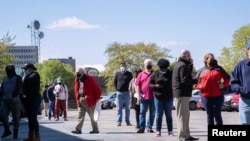 FILE - Job seekers queue outside an employment center in Louisville, Kentucky, April 15, 2021. 