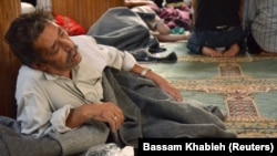 A survivor from what activists say is a gas attack rests inside a mosque in the Duma neighborhood of Damascus August 21, 2013. 