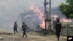 Pasukan keamanan Burma melewati sebuah perkampungan warga muslim yang dibakar di Sittwe, ibu kota negara bagian Rakhine (foto: dok).