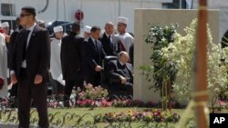 Algerian President Abdelaziz Bouteflika in a wheel chair arrives to attend the official inauguration of the Algiers' subway, April 9, 2018. 