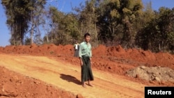 FIILE - Farmer U Thant Lwin stands on the site of his old paddy field, which has been ripped apart to make way for a gas pipeline to China, near the northeastern town of Pyin Oo Lwin, Burma, Jan. 2012.