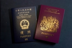 FILE - A British National Overseas passports (BNO) and a Hong Kong Special Administrative Region of the People's Republic of China passport are pictured in Hong Kong, Friday, Jan. 29, 2021.