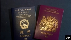 A British National Overseas passports (BNO) and a Hong Kong Special Administrative Region of the People's Republic of China passport are pictured in Hong Kong, Friday, Jan. 29, 2021. 