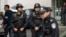 Armed policemen stand guard near the site of an explosion in Urumqi, northwest China's Xinjiang region, May 22, 2014.