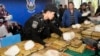 FILE - Thai policemen arrange packages of confiscated methamphetamine on a table before a press conference in Bangkok, Thailand, Feb. 15, 2013.