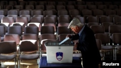 A man casts his vote at a polling station during the general election in Vodice, Slovenia, June 3, 2018.