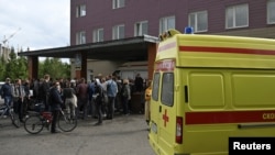 People gather outside a hospital, where Russian opposition leader Alexei Navalny receives medical treatment in Omsk, Russia August 21, 2020.