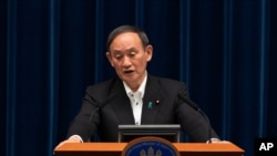 Japanese Prime Minister Yoshihide Suga responds to a reporter's question after he spoke at a news conference in Tokyo on May 7, 2021, announcing an extension of a state of emergency in Tokyo and other areas through May 31.