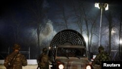 FILE - A vehicle with a fan to move away tear gas is seen near Turkey's Pazarkule border crossing, in Kastanies, Greece, March 12, 2020.