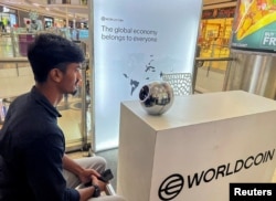 FILE - Kaleem, 22, an engineer in Bengaluru, signs up for WorldCoin by having his eyes scanned by the spherical device in Mantri Square Mall in Bengaluru, India July 25, 2023. (REUTERS/Medha Singh)