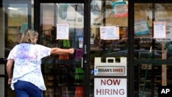 A hiring sign is displayed outside a retail store in Buffalo Grove, Illinois, June 24, 2021. 
